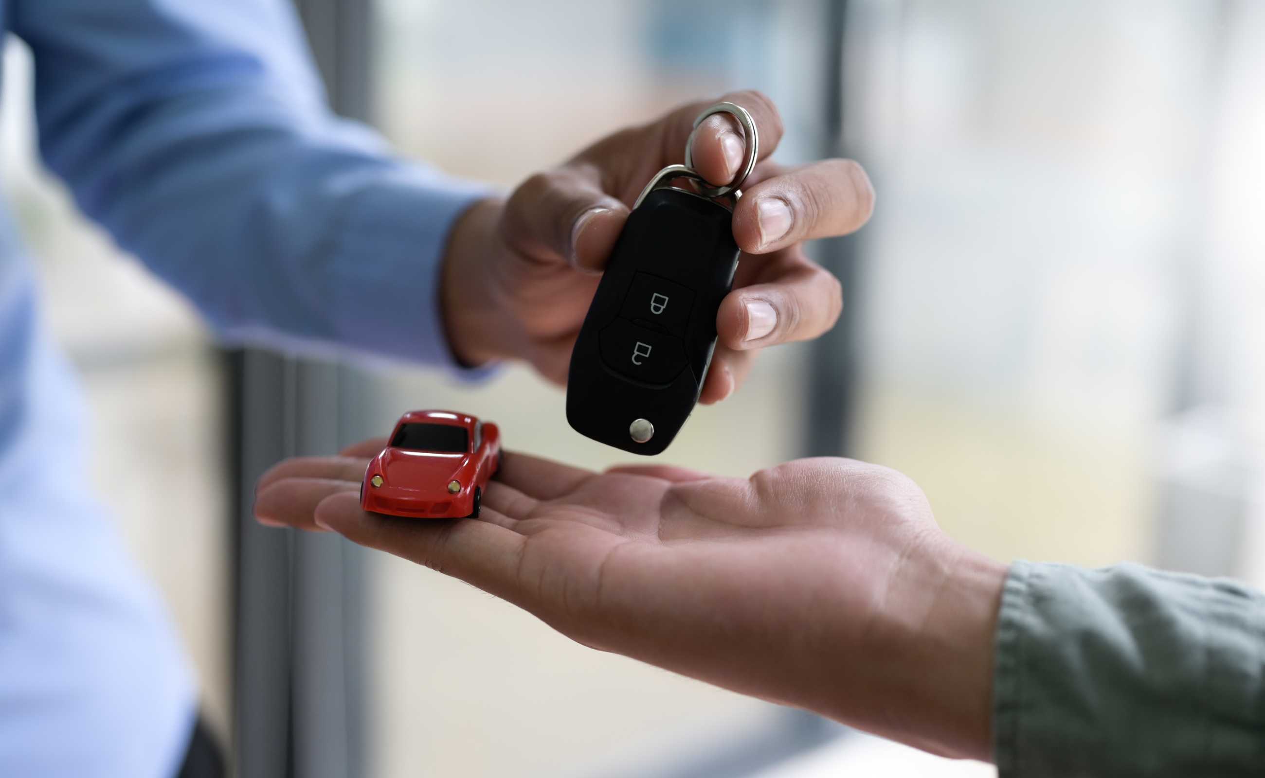 Keys for a Car being handed over after a sale. | Featured image for the Can You Sell a Car on Finance Blog from Fido Finance.