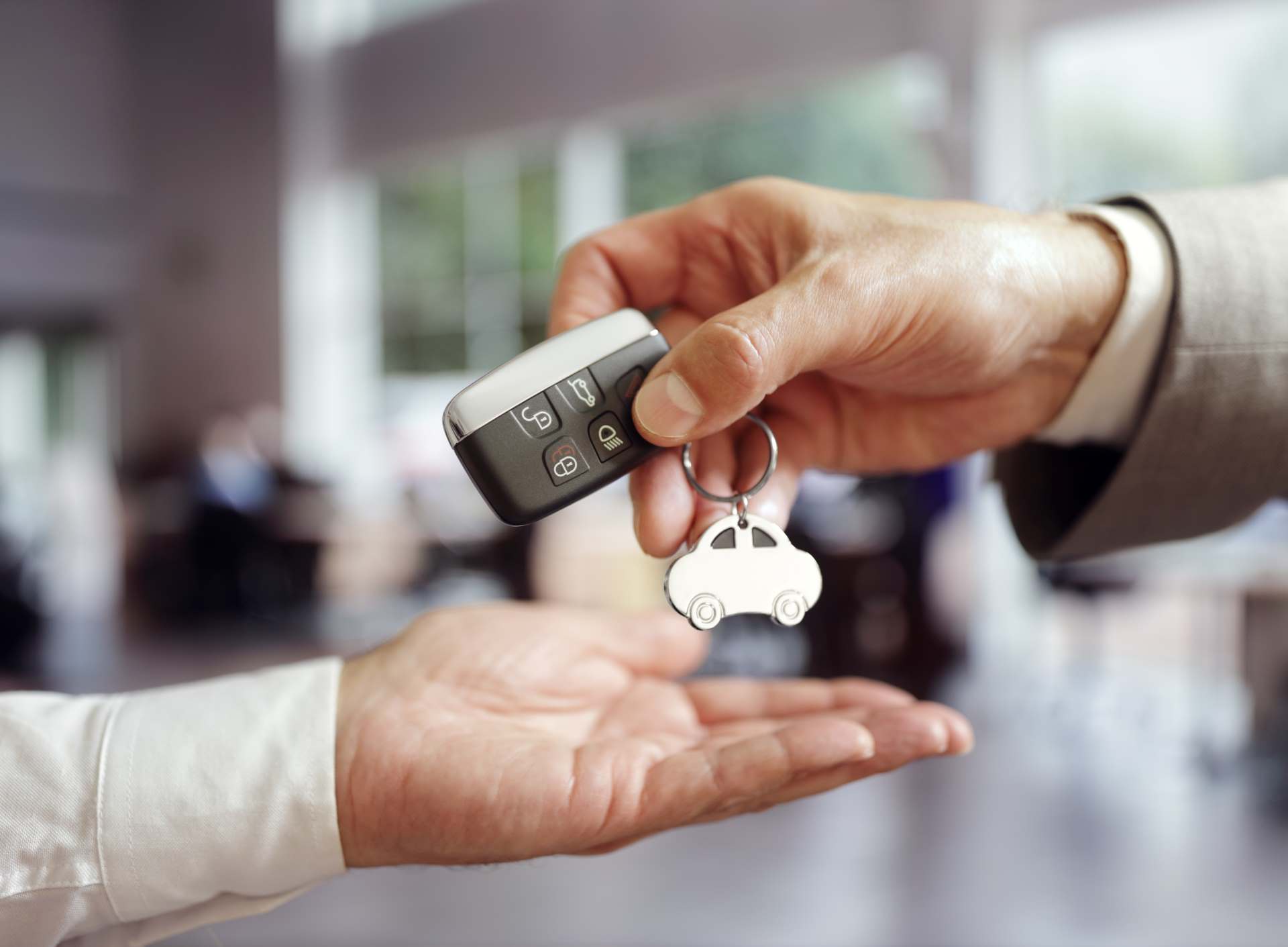 Car keys being handed over | Featured image for the Comparing Car Leasing vs Car Financing Blog from Fido Finance.