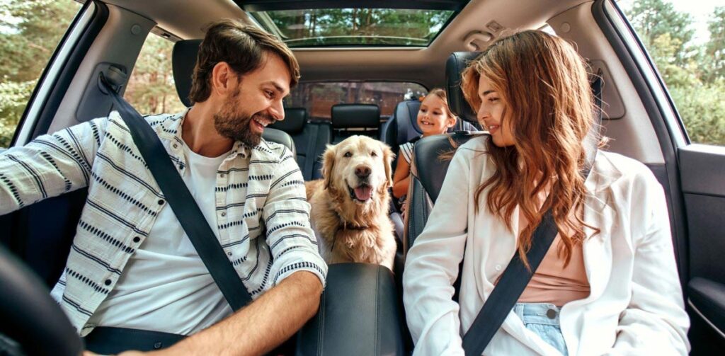 Image of Young Family & Dog in an SUV | Featured image for the Best Affordable Cars for Families Blog from Fido Finance.