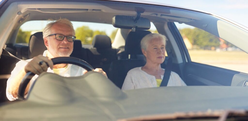 Happy Senior Couple Driving Their Car | Featured image for the Guide to Car Finance for Pensioners Blog from Fido Finance.